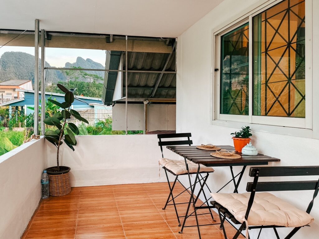 Homestay entrance surrounded by tropical plants